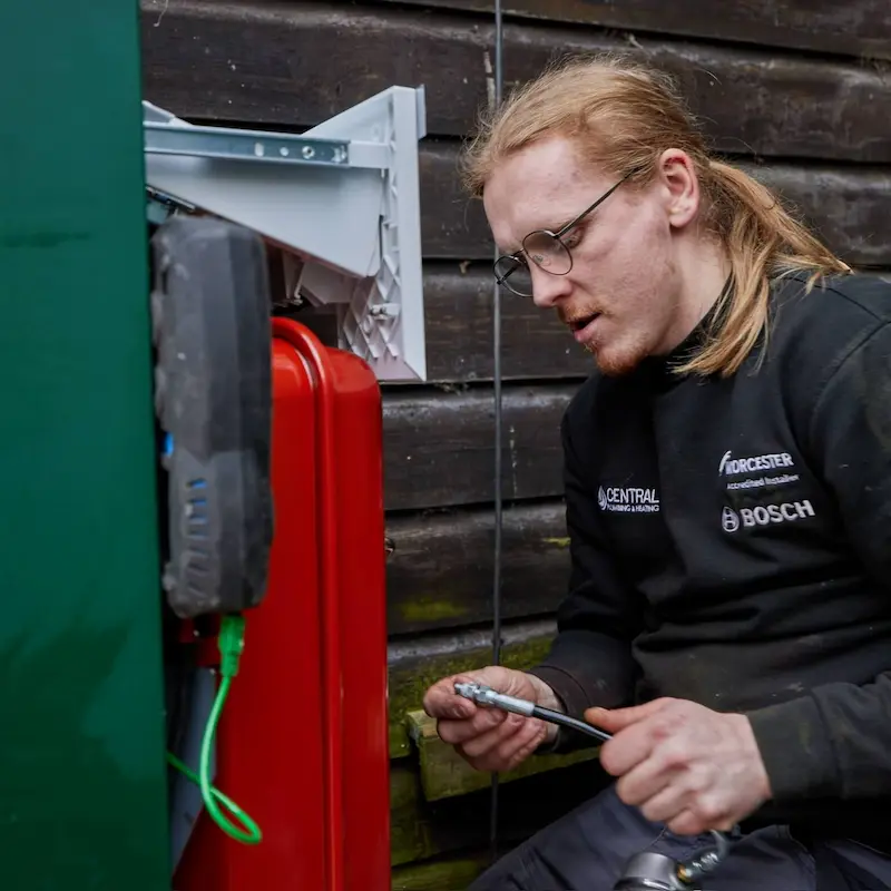 Vector Heat engineer installing an external Worcester Bosch oil boiler